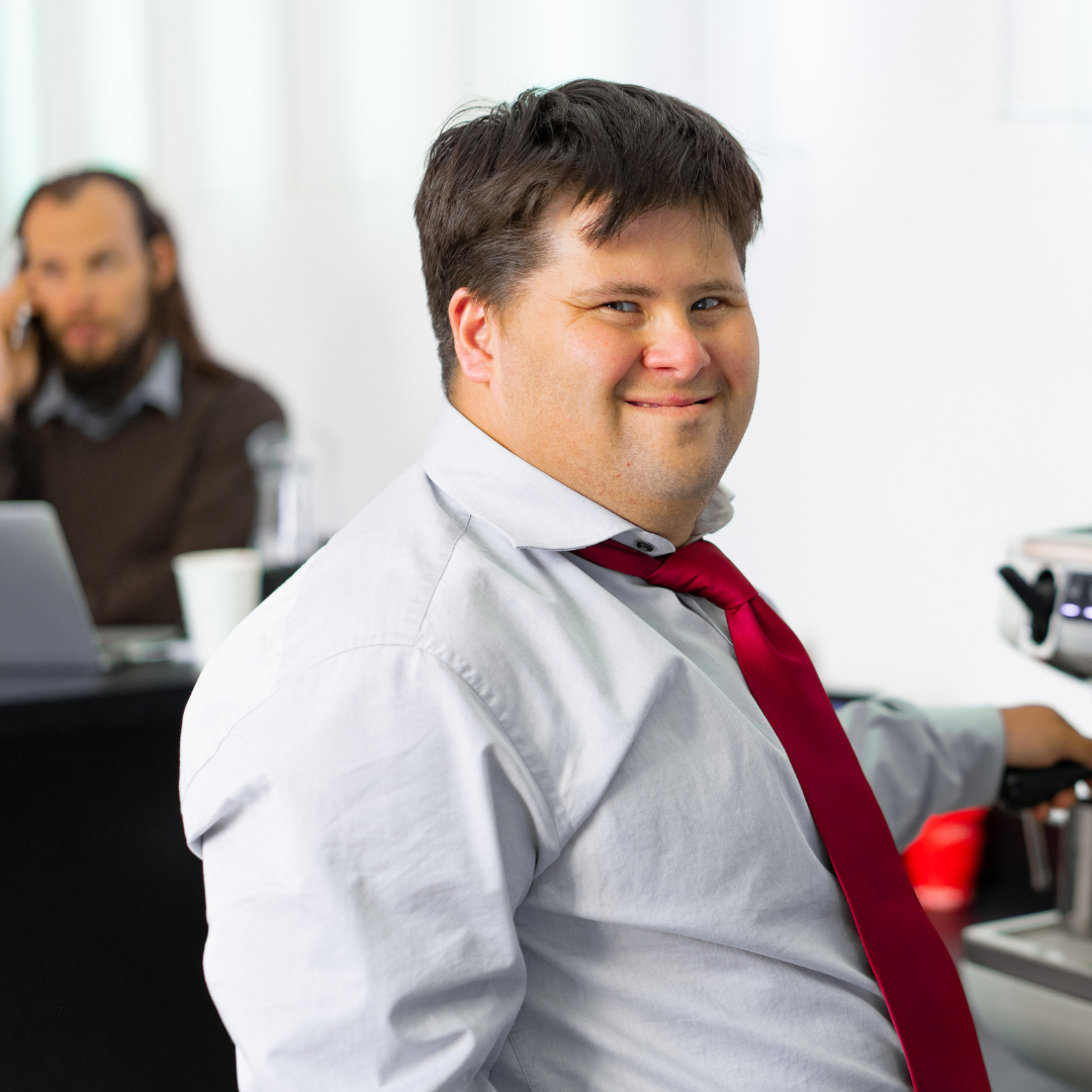 Participant in an apron smiling in the retail lab